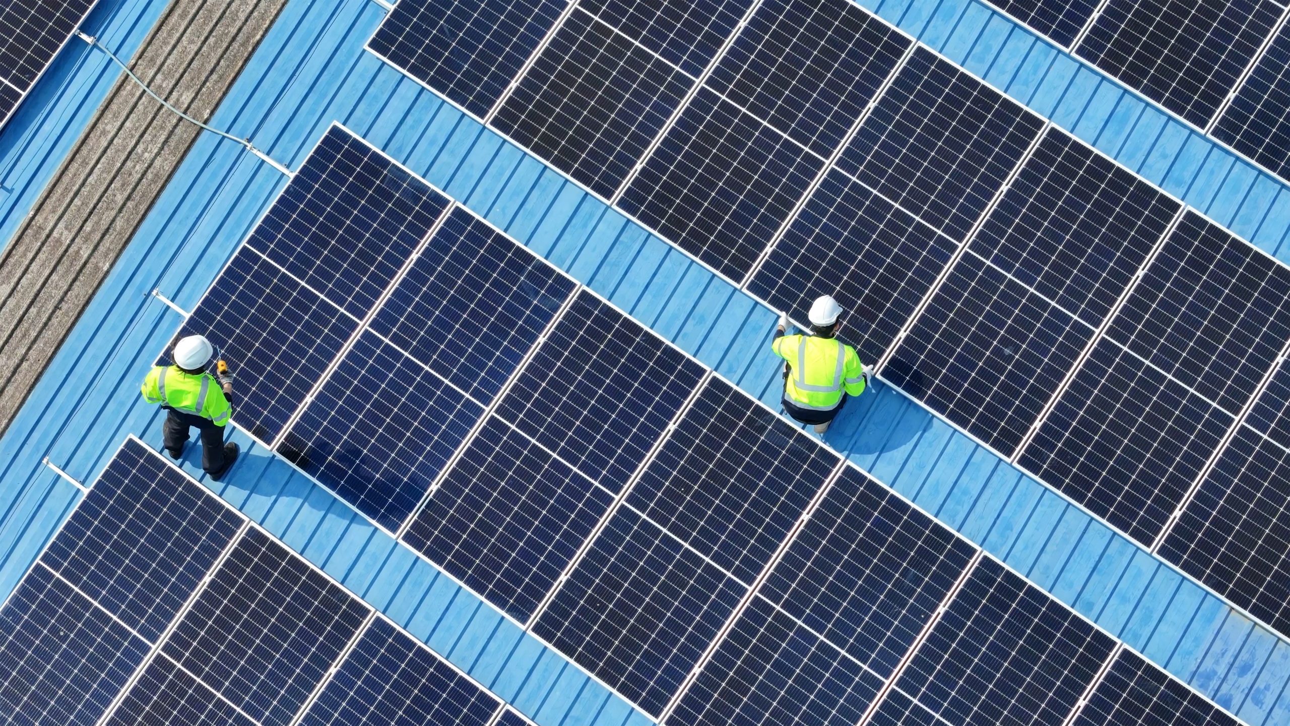 GreenWatt Energy engineer measuring solar output on a commercial installation